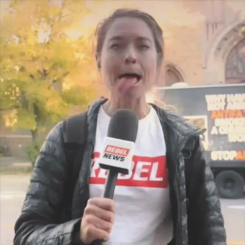 A Woman Wearing A Rebel News T-Shirt Is Holding A Microphone GIF