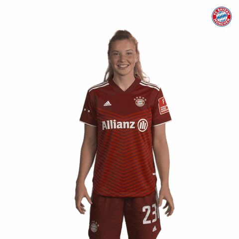 A Woman Wearing A Red Allianz Jersey With The Number 23 On Her Shorts GIF