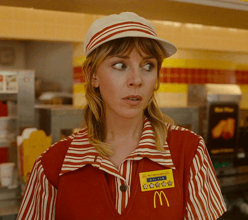 A Woman Wearing A Red And White Striped Mcdonald 'S Uniform With A Yellow Mcdonald 'S Badge GIF