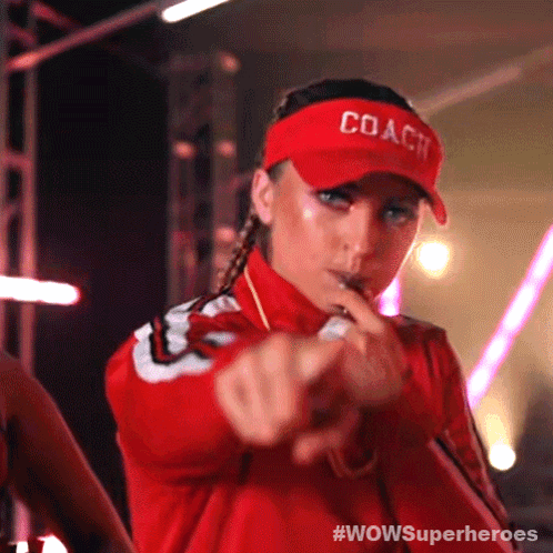 A Woman Wearing A Red Coach Hat Is Pointing Her Finger GIF