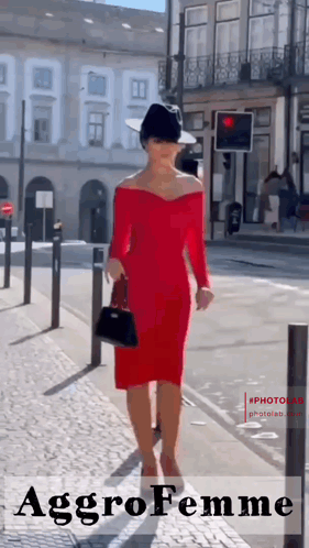 Woman In Red Dress And Black Hat Walking Down Street GIF