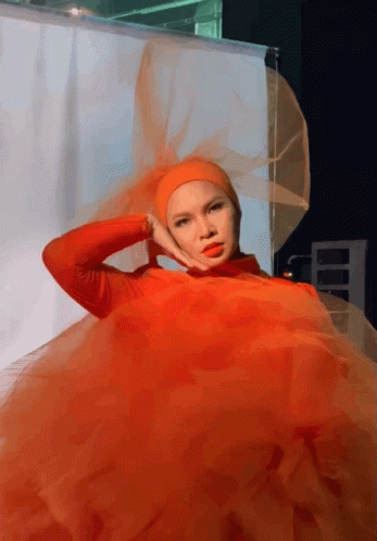 A Woman Wearing A Red Dress And A Hijab GIF