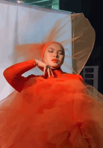 A Woman Wearing A Red Dress And A Veil GIF