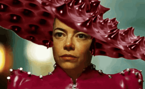 a woman wearing a red hat and a red latex dress