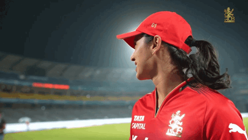 A Woman Wearing A Red Hat And A Red Shirt That Says Tata Capital GIF