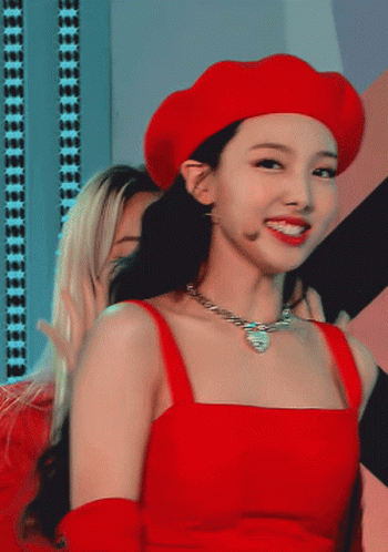 A Woman Wearing A Red Hat And A Red Top GIF