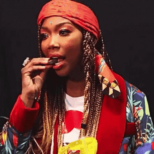 Woman Eating Chocolate Bar In Red Jacket GIF