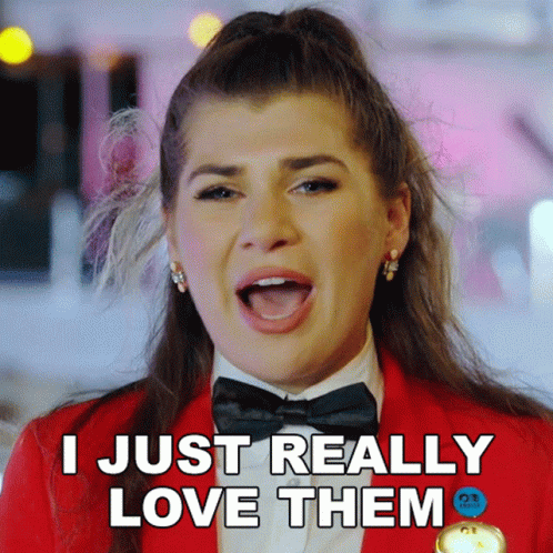 Woman In Red Jacket And Bow Tie Says I Love Them GIF