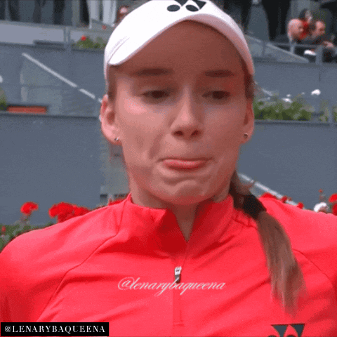 a woman wearing a red jacket and a white yonex hat with the name lenarybaqueena on the bottom