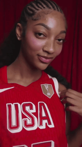 a woman wearing a red jersey that says usa on the front
