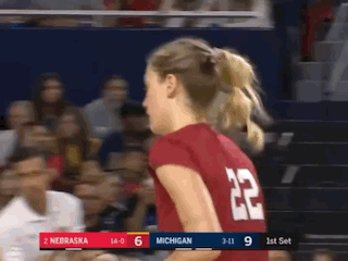 a woman wearing a red jersey with the number 22 on the back