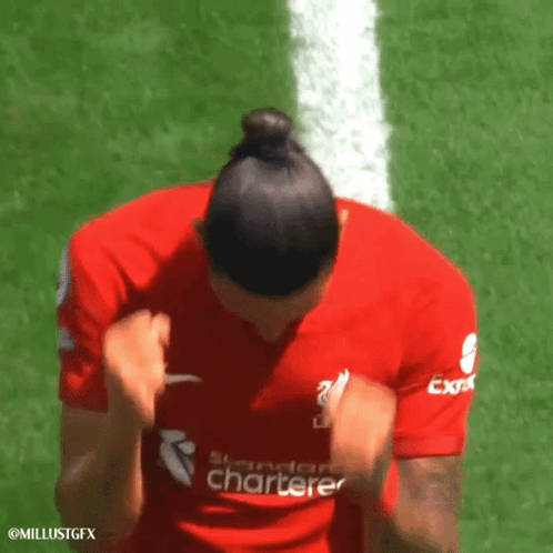A Woman Wearing A Red Shirt That Says Standard Chartered GIF
