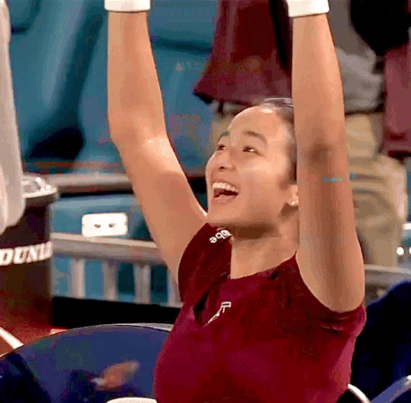 A Woman Wearing A Red Shirt With The Letter F On It GIF