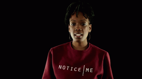 A Woman Wearing A Red Sweatshirt With The Word Tic On The Front GIF