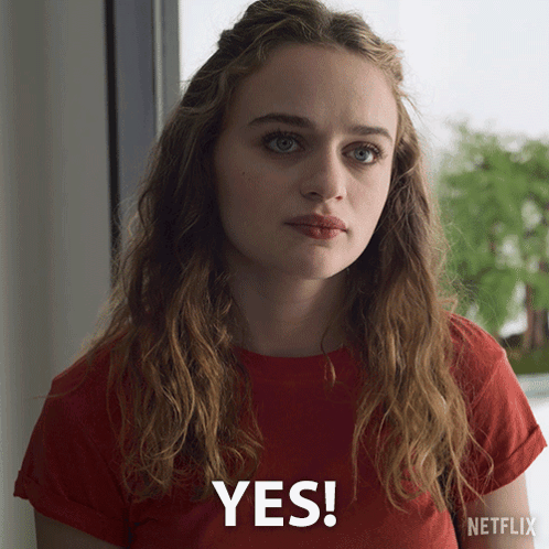 A Woman Wearing A Red T-Shirt Says Yes GIF