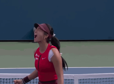 A Woman Wearing A Red Tank Top And A Visor With The Word Nike On It GIF