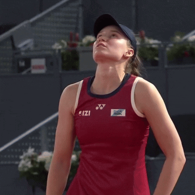 a woman wearing a red tank top with the word izio on it