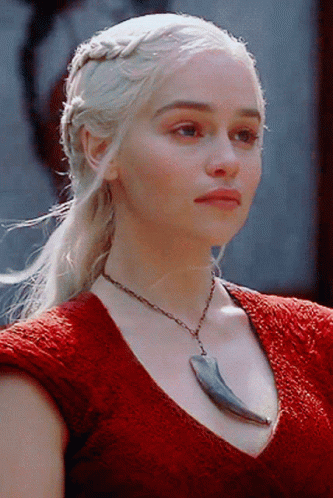 A Woman Wearing A Red Top And A Necklace With A Claw On It GIF