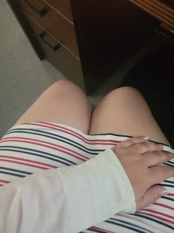 A Woman Wearing A Red White And Blue Striped Skirt Holds Her Hands To Her Chest GIF