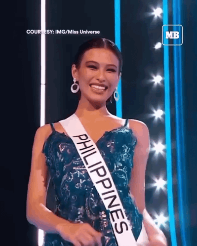 A Woman Wearing A Sash That Says Philippines Is Smiling GIF