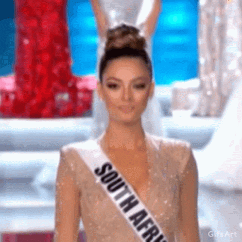 A Woman Wearing A Sash That Says South Africa On It GIF