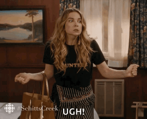 Woman In Counter Shirt Holding Ugh GIF