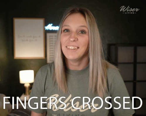 A Woman Wearing A Shirt That Says Fingers Crossed On It GIF