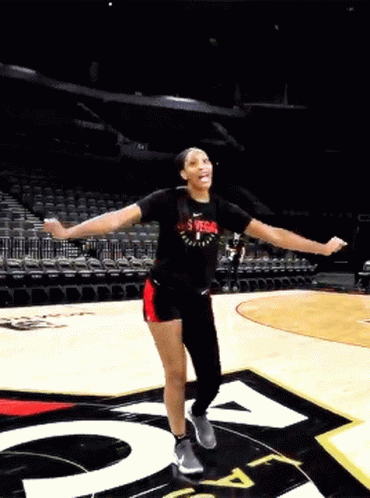 A Woman Wearing A Shirt That Says Las Vegas On It Is Dancing On A Basketball Court GIF