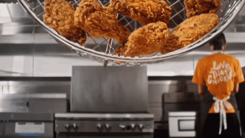 A Woman Wearing A Shirt That Says Love Chicken Is Cooking Chicken GIF