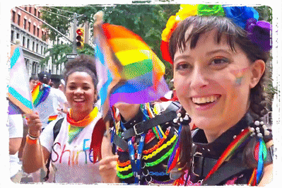 A Woman Wearing A Shirt That Says " Shine " Smiles While Holding A Rainbow Flag GIF