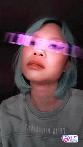 A Woman Wearing A Shirt That Says ' Stay Home ' On It GIF