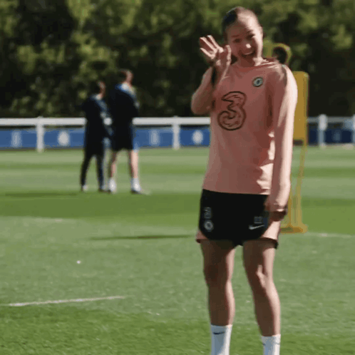 A Woman Wearing A Shirt With The Number 3 On It GIF