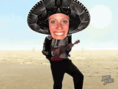 A Woman Wearing A Sombrero Is Playing A Guitar GIF