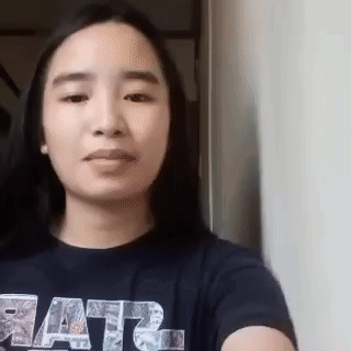 A Woman Wearing A Star Wars Shirt Is Taking A Selfie With Her Phone . GIF