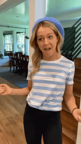 A Woman Wearing A Striped Shirt And A Blue Beret GIF