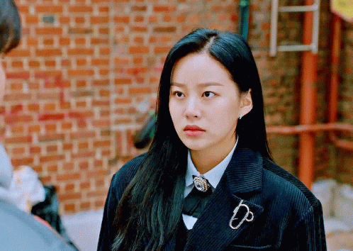 A Woman Wearing A Suit With A Brooch That Says Dp On It GIF