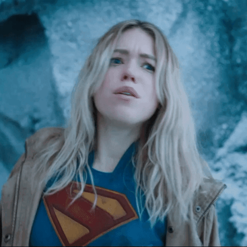 A Woman Wearing A Superman T-Shirt And A Jacket GIF