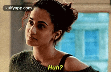 A Woman Wearing A Sweater And A Black Bra Is Talking To Another Woman . GIF