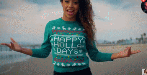 A Woman Wearing A Sweater That Says Happy Holly Days On It GIF