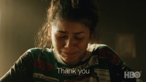 A Woman Wearing A Sweater That Says Thank You On It GIF