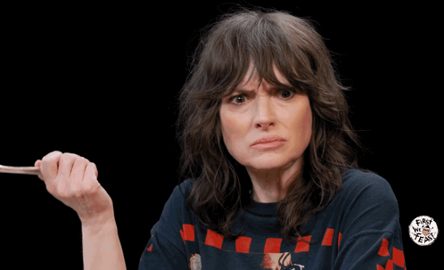 a woman wearing a t-shirt that says " easy tiger " applauds