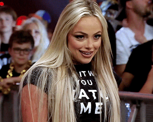 A Woman Wearing A T-Shirt That Says " It 'S You At Me " GIF