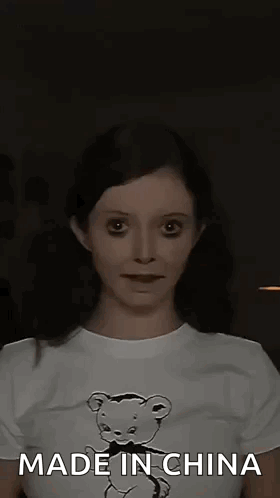 A Woman Wearing A T-Shirt With A Teddy Bear On It Is Making A Funny Face . GIF