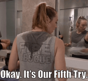 A Woman Wearing A Tank Top That Says Fire Rescue On It GIF
