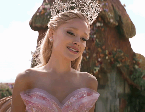 A Woman Wearing A Tiara And A Pink Dress GIF