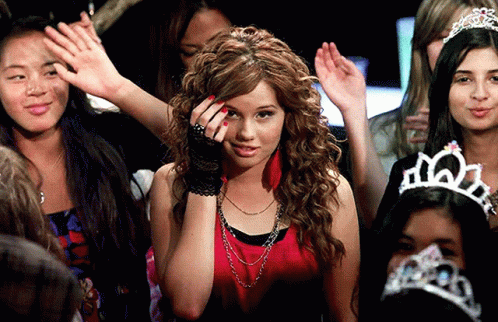 A Woman Wearing A Tiara Stands In A Crowd GIF