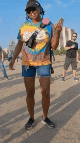 A Woman Wearing A Tie Dye Shirt With San Diego On It GIF