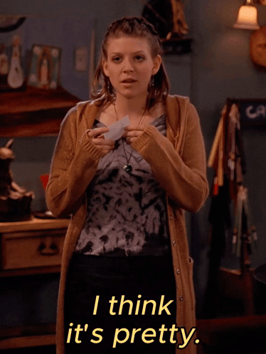 A Woman Wearing A Tie Dye Top And A Tan Cardigan Says I Think It 'S Pretty GIF