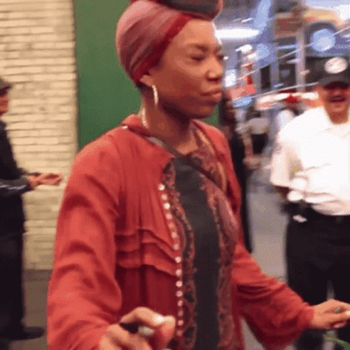 Woman Wearing Turban And Red Jacket Walking GIF