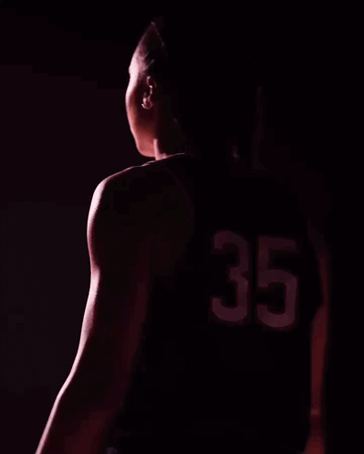 A Woman Wearing A Uconn Jersey With The Number 35 GIF